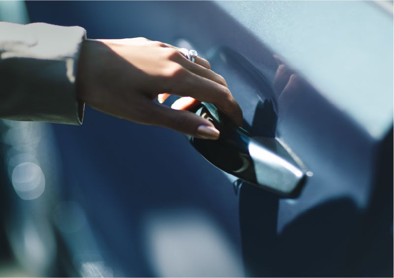 A hand gracefully grips the Light Touch Handle of a 2023 Lincoln Aviator® SUV to demonstrate its ease of use | J.C. Lewis Lincoln in Savannah GA