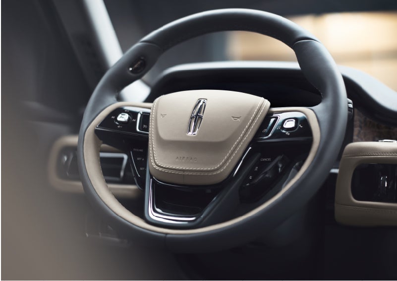 The intuitively placed controls of the steering wheel on a 2023 Lincoln Aviator® SUV | J.C. Lewis Lincoln in Savannah GA