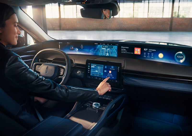 The driver of a 2024 Lincoln Nautilus® SUV interacts with the center touchscreen. | J.C. Lewis Lincoln in Savannah GA