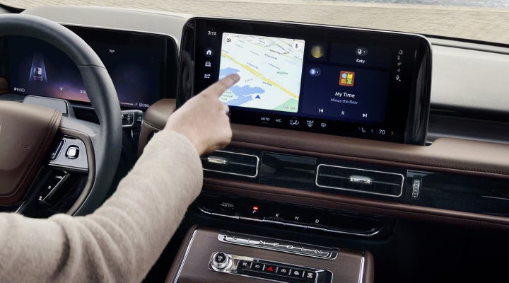A person is tapping the center display touchscreen of a 2026 Lincoln Aviator® SUV. | J.C. Lewis Lincoln in Savannah GA