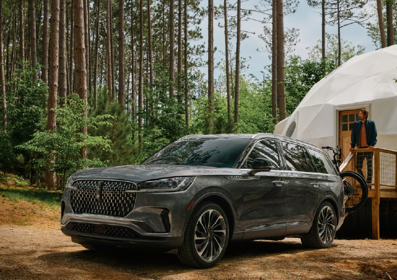 A 2027 Lincoln Aviator® is parked next to a high end glamping site. | J.C. Lewis Lincoln in Savannah GA