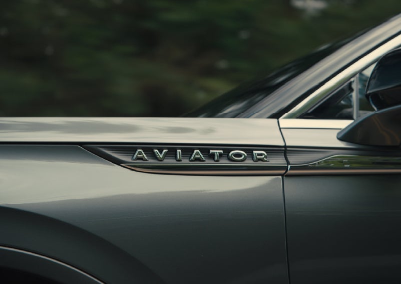 The driver’s side door and fender badging of a gray 2027 Lincoln Aviator® SUV are showcased. | J.C. Lewis Lincoln in Savannah GA