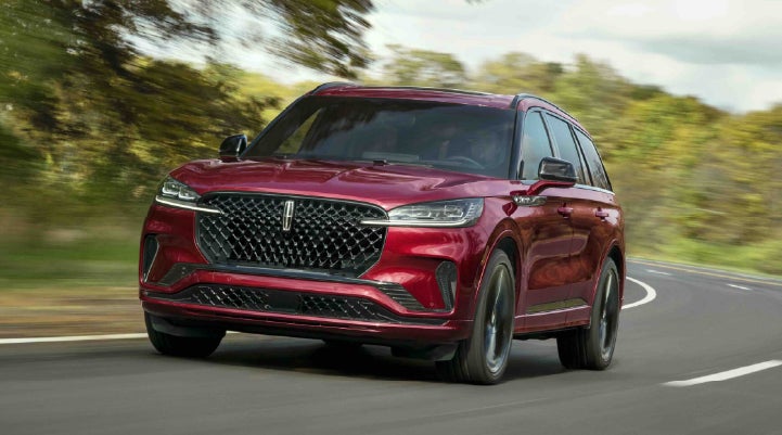 A 2027 Lincoln Aviator® SUV is being driven on a country road | J.C. Lewis Lincoln in Savannah GA
