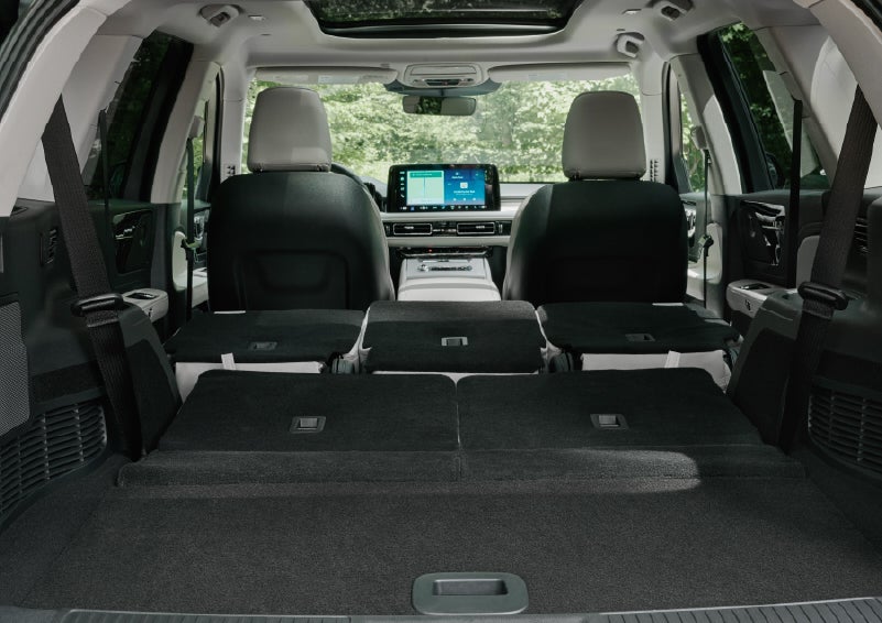 A rear to front view of the interior of a 2027 Lincoln Aviator® Black Label™ SUV shows the third and second rows folded flat | J.C. Lewis Lincoln in Savannah GA