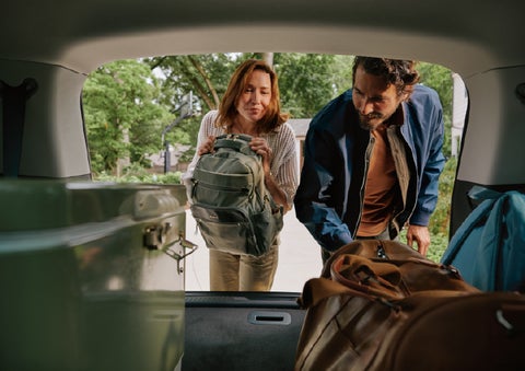 A couple loads luggage into the rear of a 2027 Lincoln Aviator® Black Label™ SUV..e 202 | J.C. Lewis Lincoln in Savannah GA
