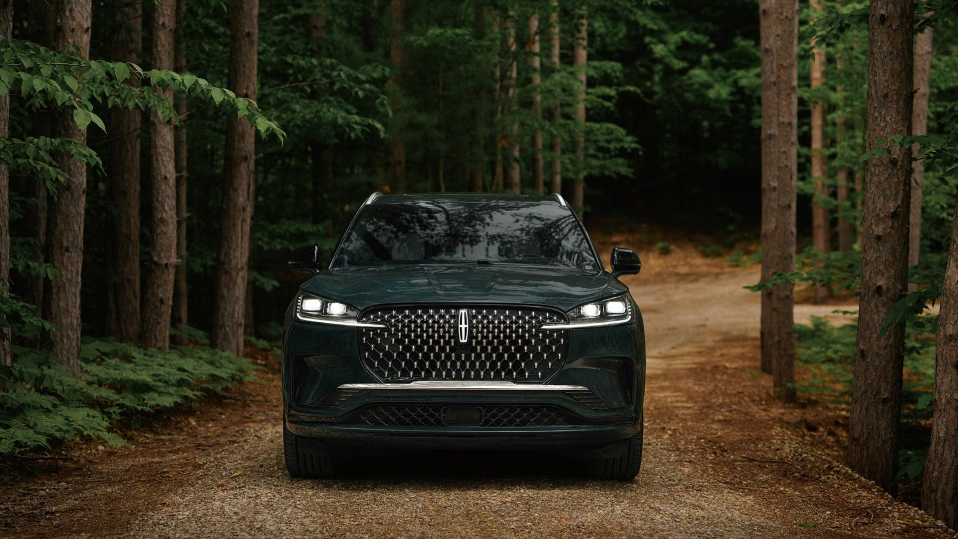 2027 Lincoln Aviator on a wooded road