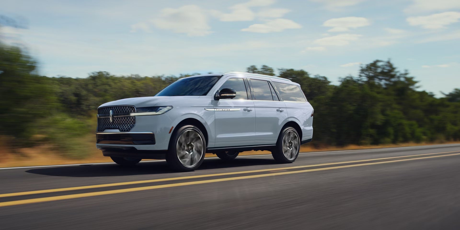 2027 light blue/grey Navigator driving